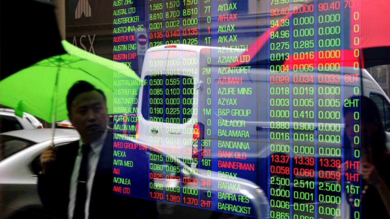 Pedestrians reflected in a window at the Australian Stock Exchange (ASX) in Sydney, Monday, Feb. 9, 2015. (AAP Image/Joel Carrett) NO ARCHIVING