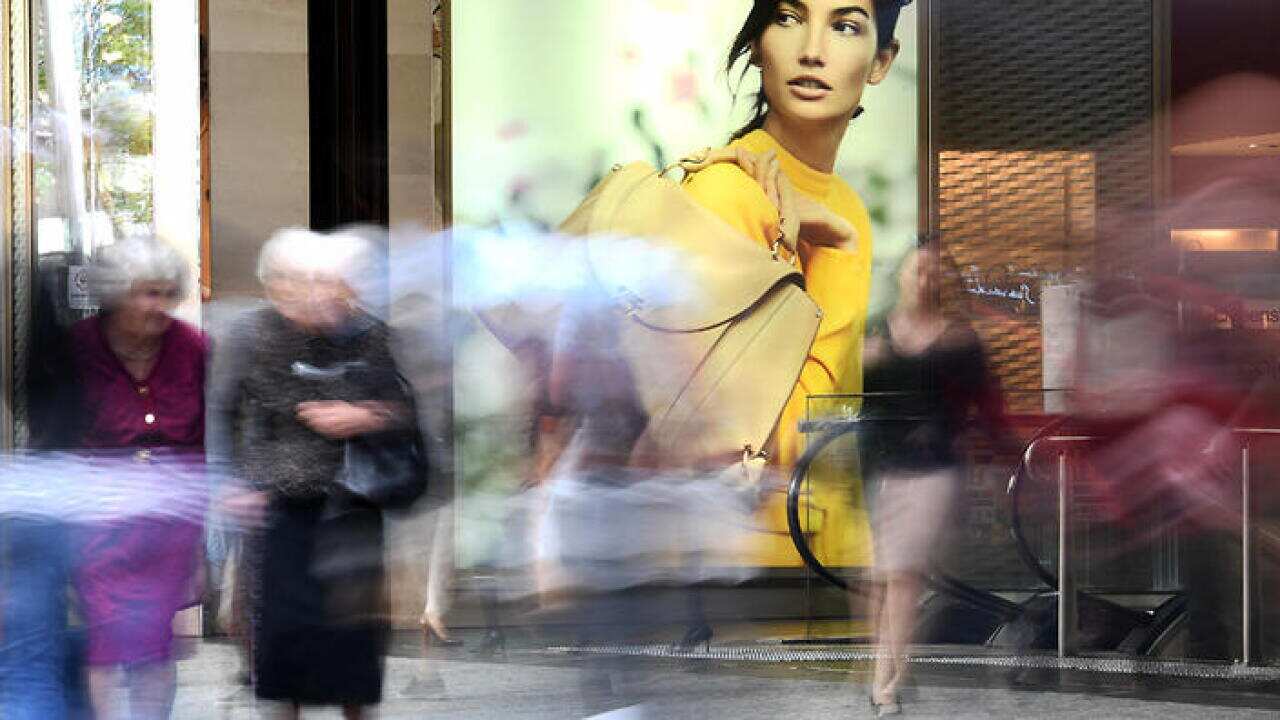 Shoppers walk past retail advertising in the Queen Street Mall in central Brisbane, Thursday, May 11, 2017. (AAP Image/Dave Hunt) NO ARCHIVING