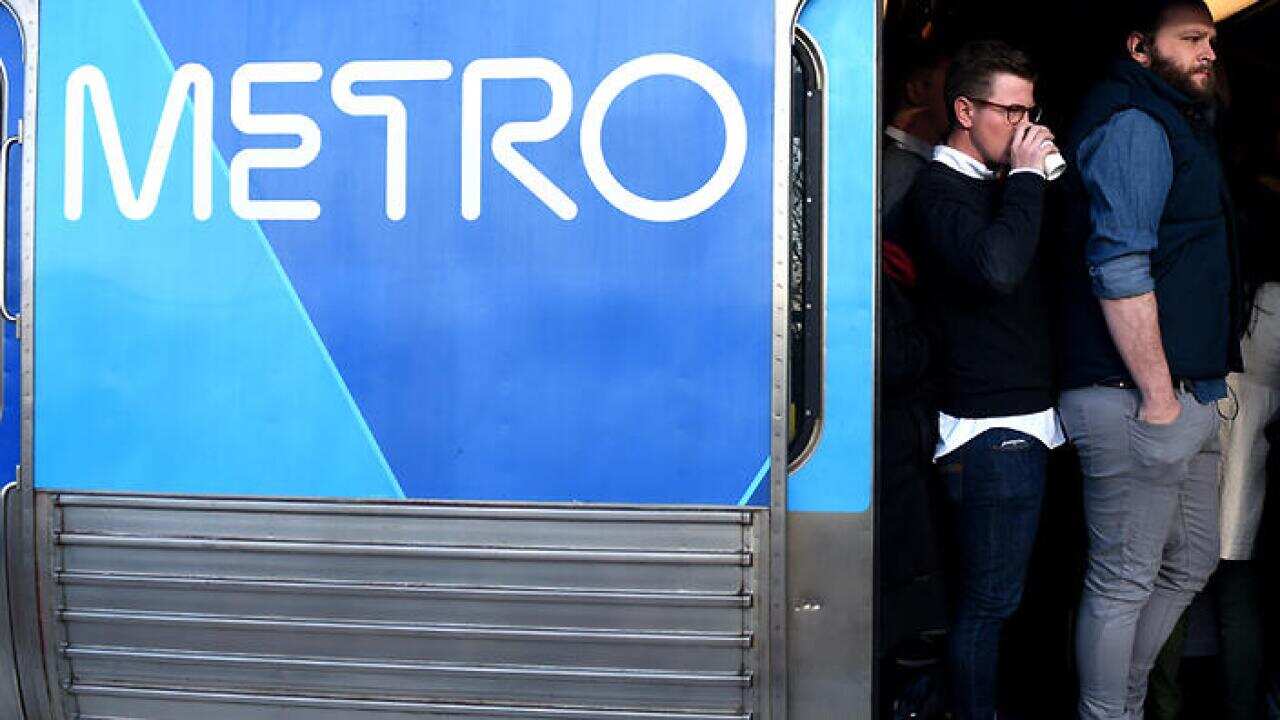 Peak hour commuters cram into a city loop train at Newmarket Station ahead of a train strike in Melbourne.