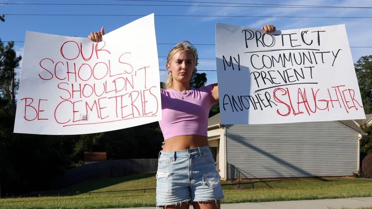 18-year old Gretchen Gierlach protests against the school shooting in Georgia (AAP)