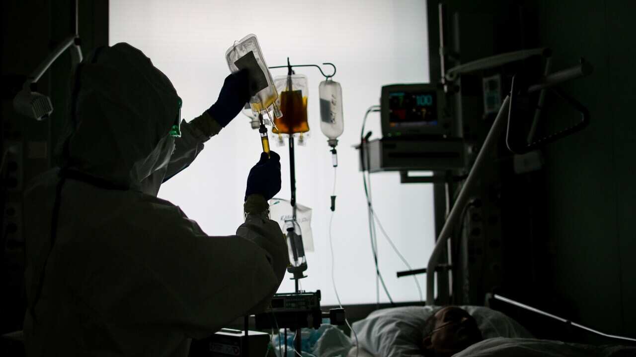 An employee and a patient at an intensive care unit