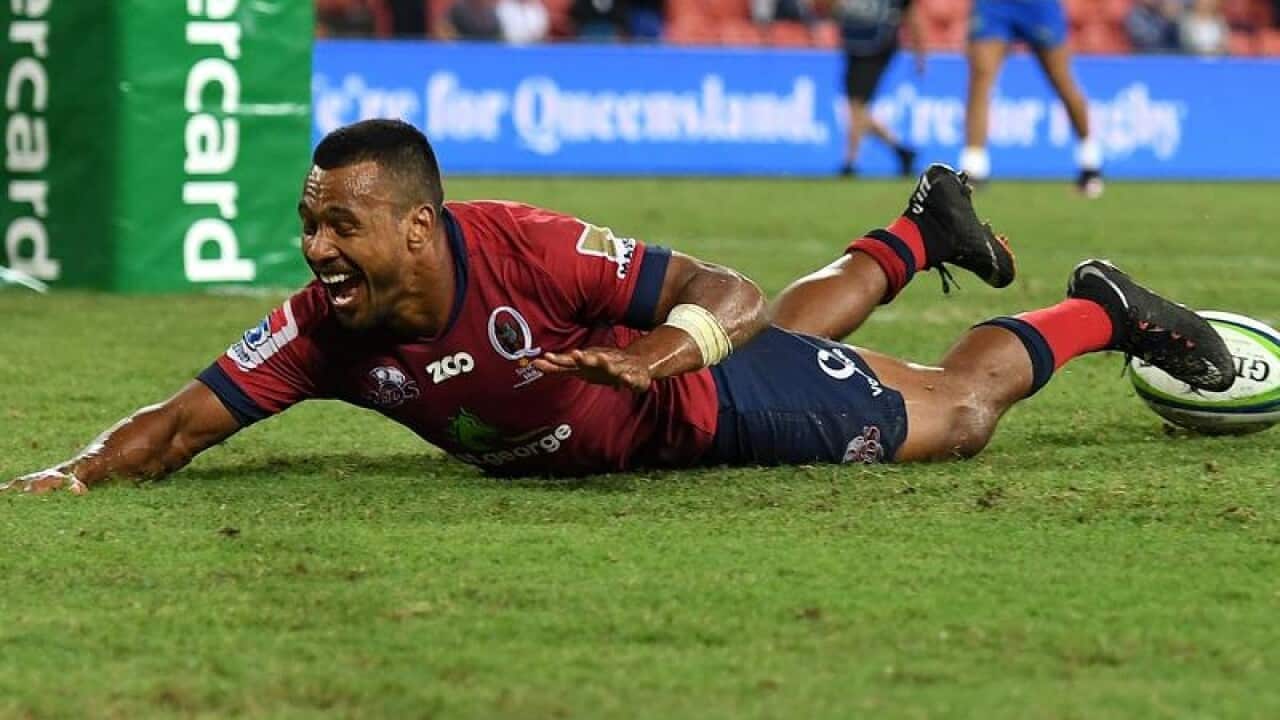 Aidan Toua of the Reds scores a try