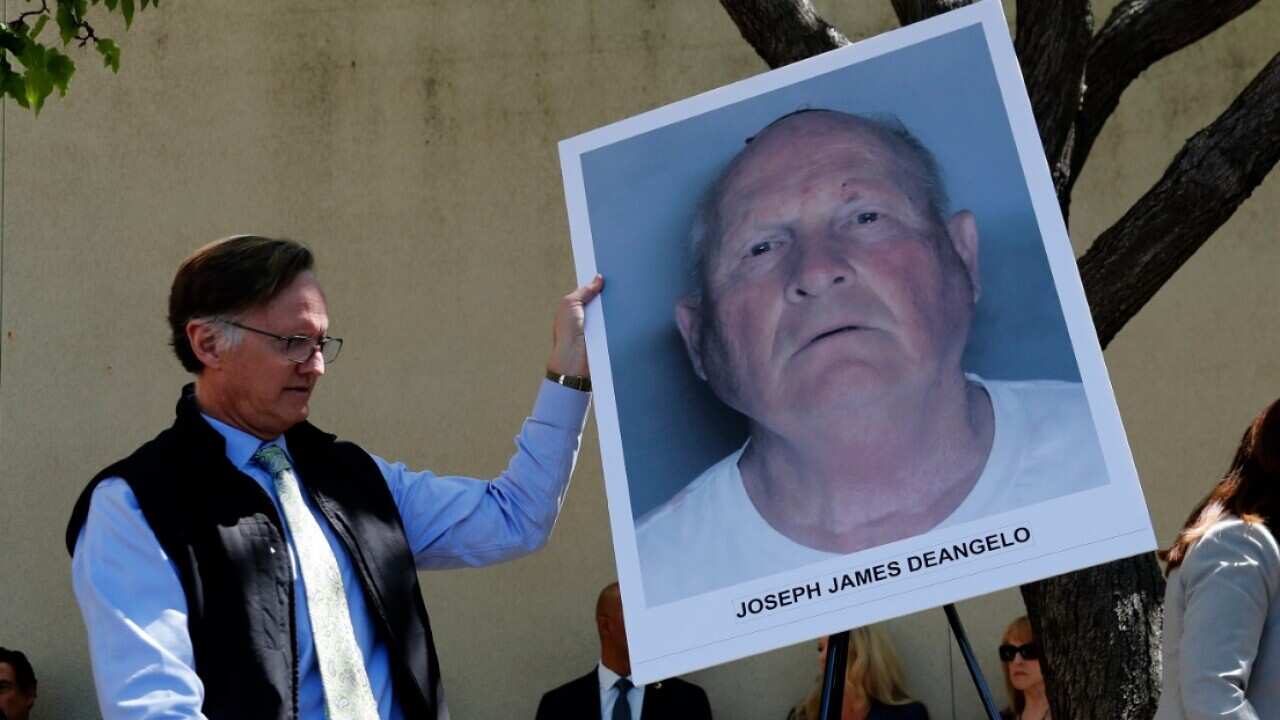 An official puts a mug shot on an easel stand, of the suspect identified as Joseph James DeAngelo, 72, a former police officer in Visalia and Auburn