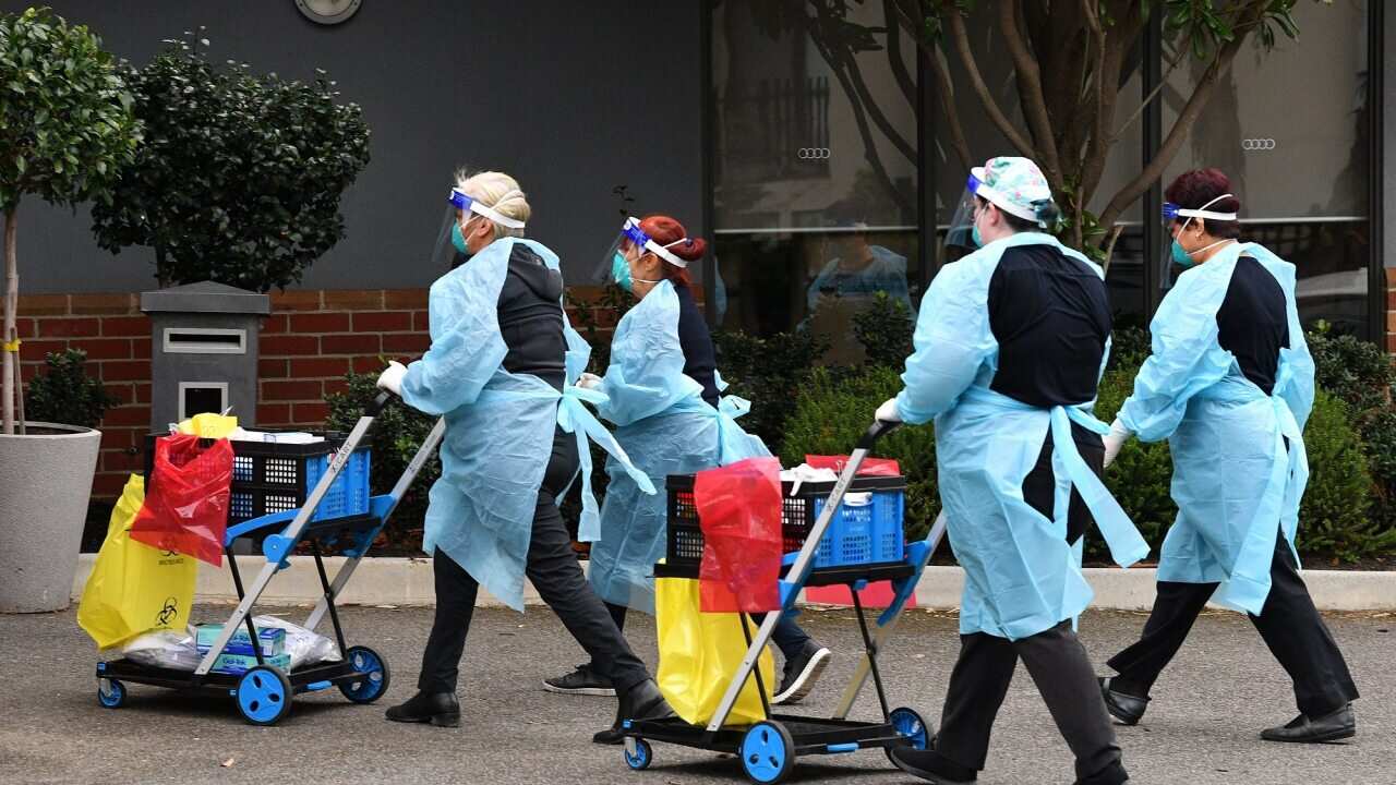 Healthcare workers arrive at the Arcare Aged Care facility in Maidstone, Melbourne, on 1 June 2021.