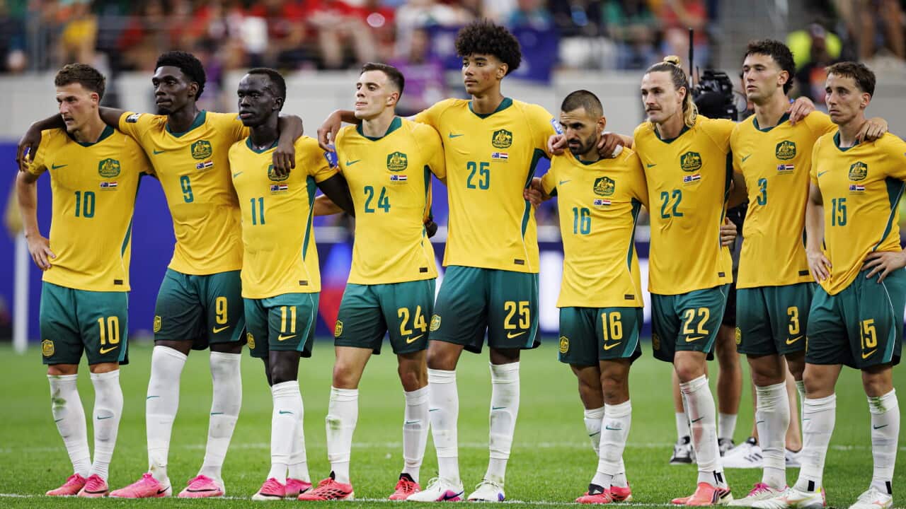 A group of Australian footballers standing shoulder to shoulder