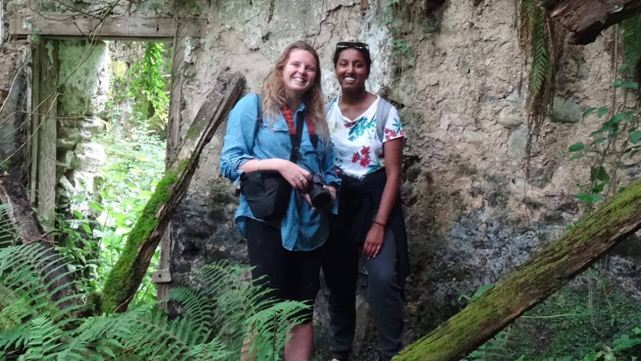 Kara (L) and Zoe (R) standing in a ruined farmhouse in the Basque mountains of Spain.