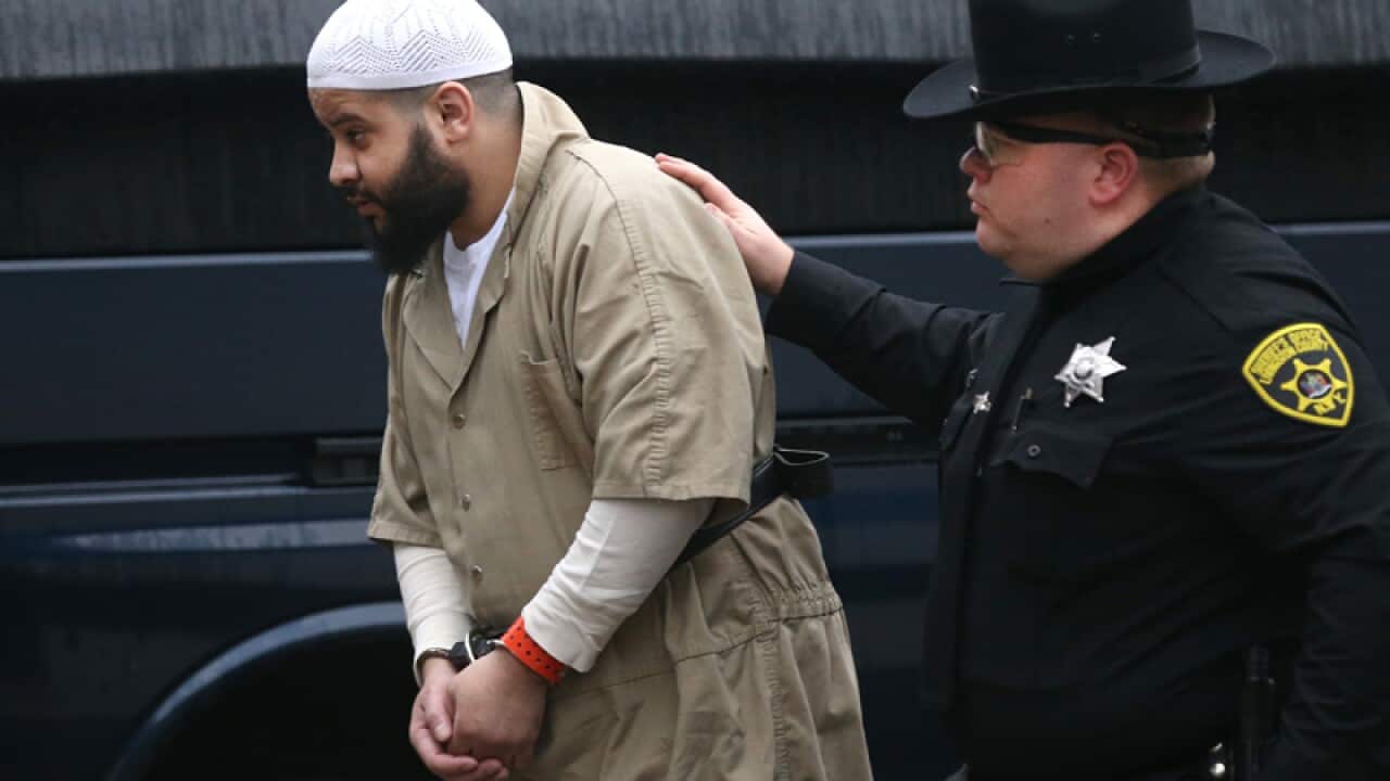 Mufid Elfgeeh is escorted under heavy guard