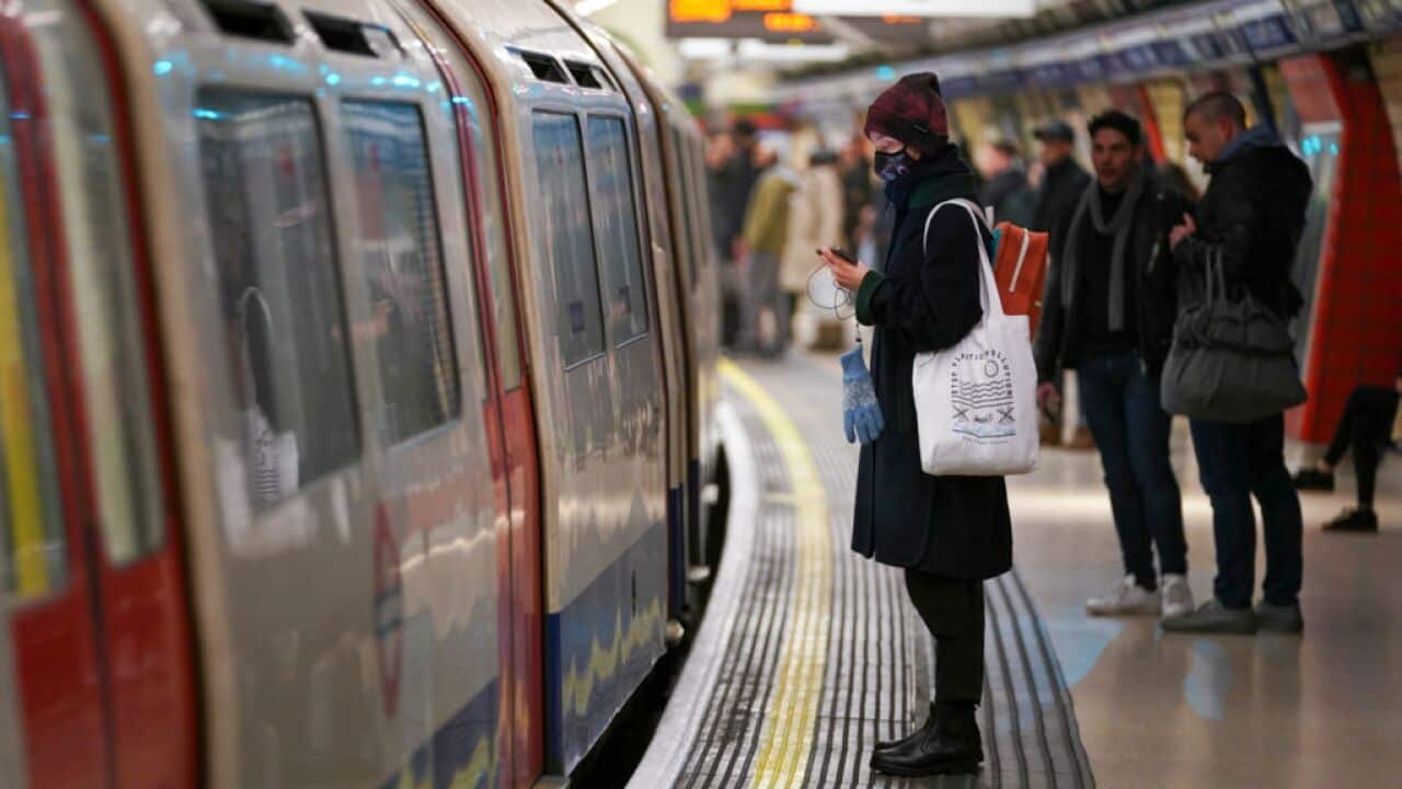 People wait for the tube in London.
