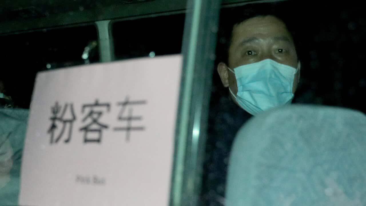 Australian evacuees leave by bus after arriving at the airport on Christmas Island.