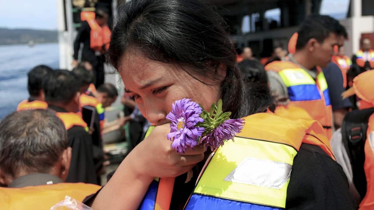 A relative weeps during a prayer for the victims of the ferry that sank on June 18.