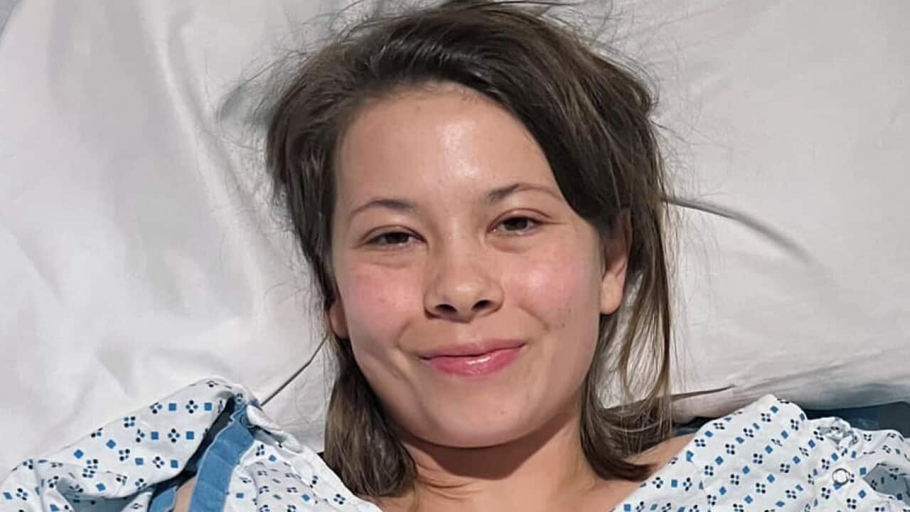 A woman with brown hair in a hospital bed