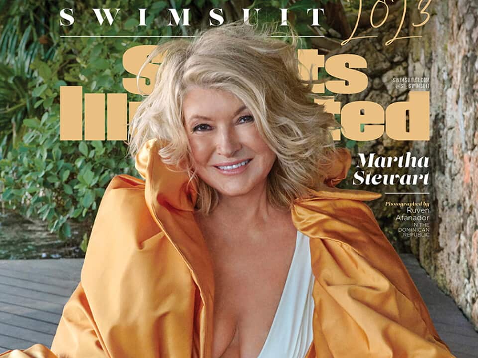 Martha Stewart in white swimsuit and orange jacket on the cover of Sports Illustrated Swimsuit edition 2023.