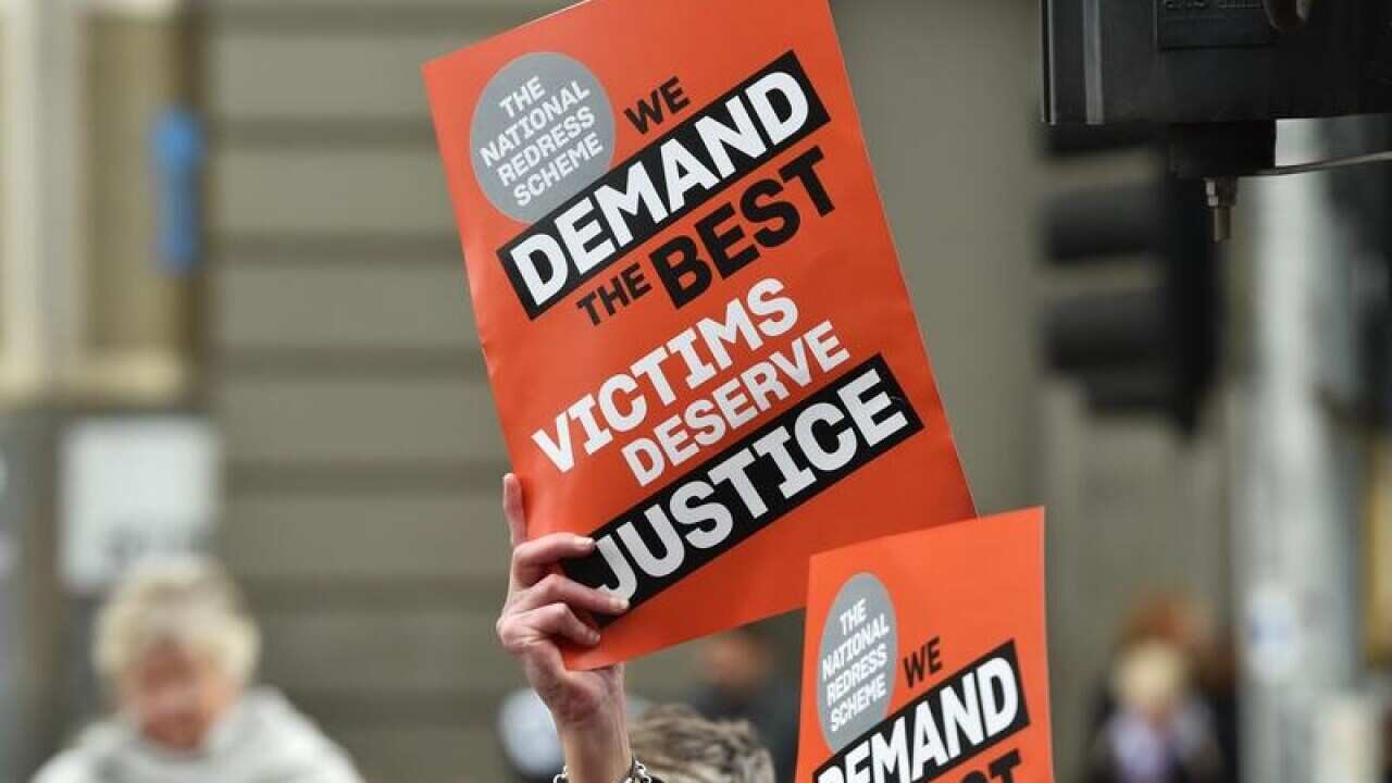 Protesters are seen outside of the Victorian State Parliament.