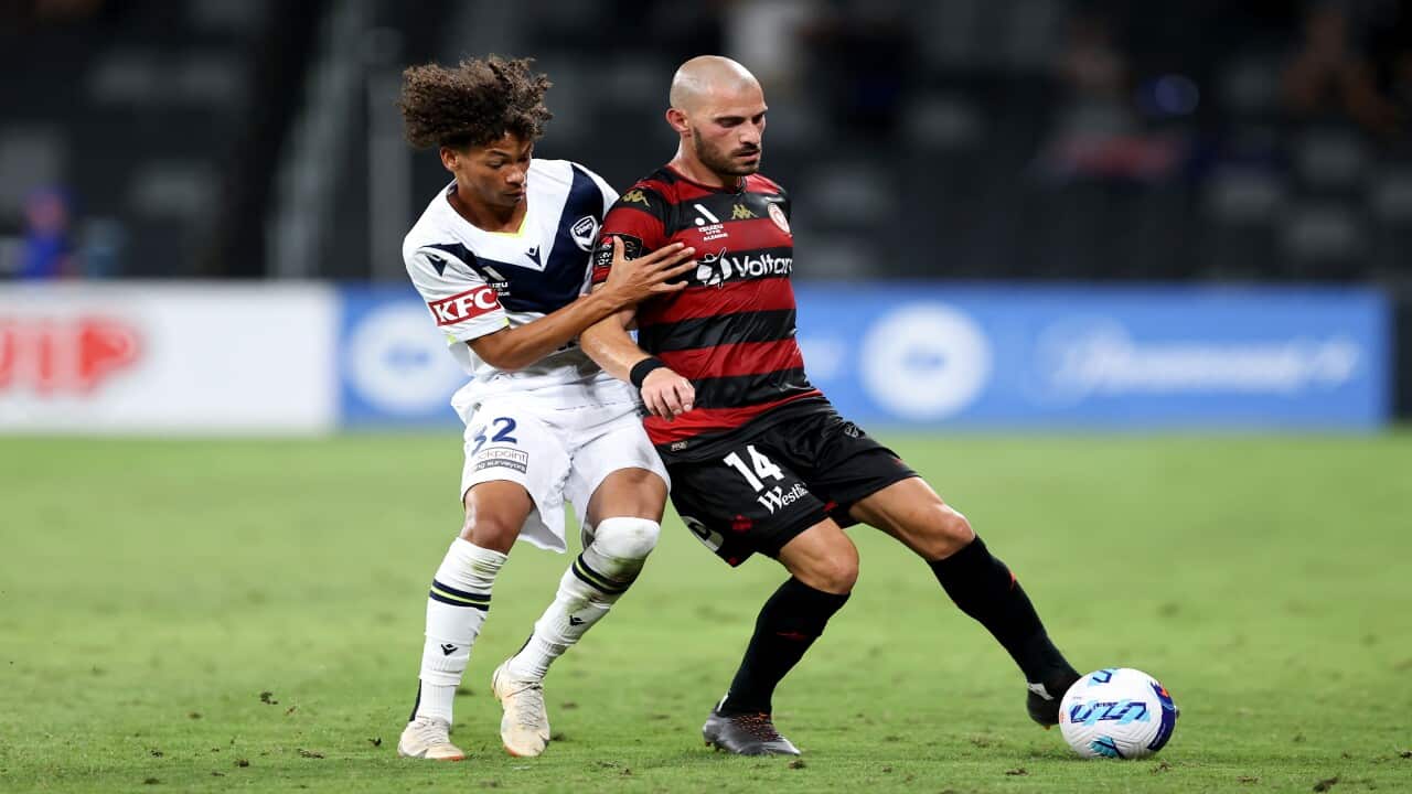 James Troisi of the Wanderers competes with William Wilson of the Victory during the A-League match between the Western Sydney Wanderers and Melbourne Victory.