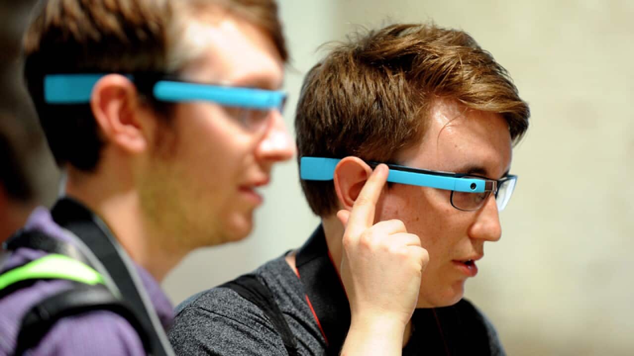 People try Google Glass during the launch in the UK