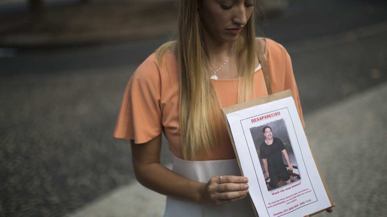 Bonnie Cuthbert, of Australia, shows a photo of her missing boyfriend Rye Hunt, 25, during a press conference in Rio de Janeiro, Brazil on Friday