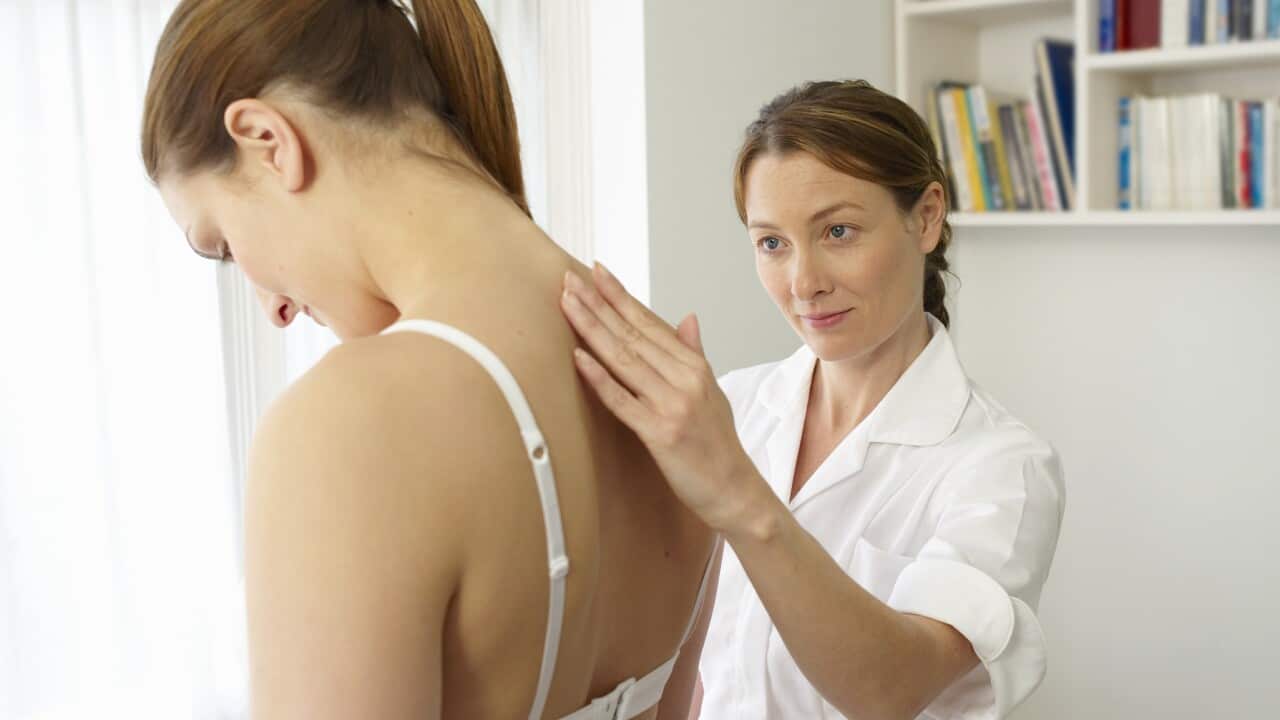 Osteopath treating patient.