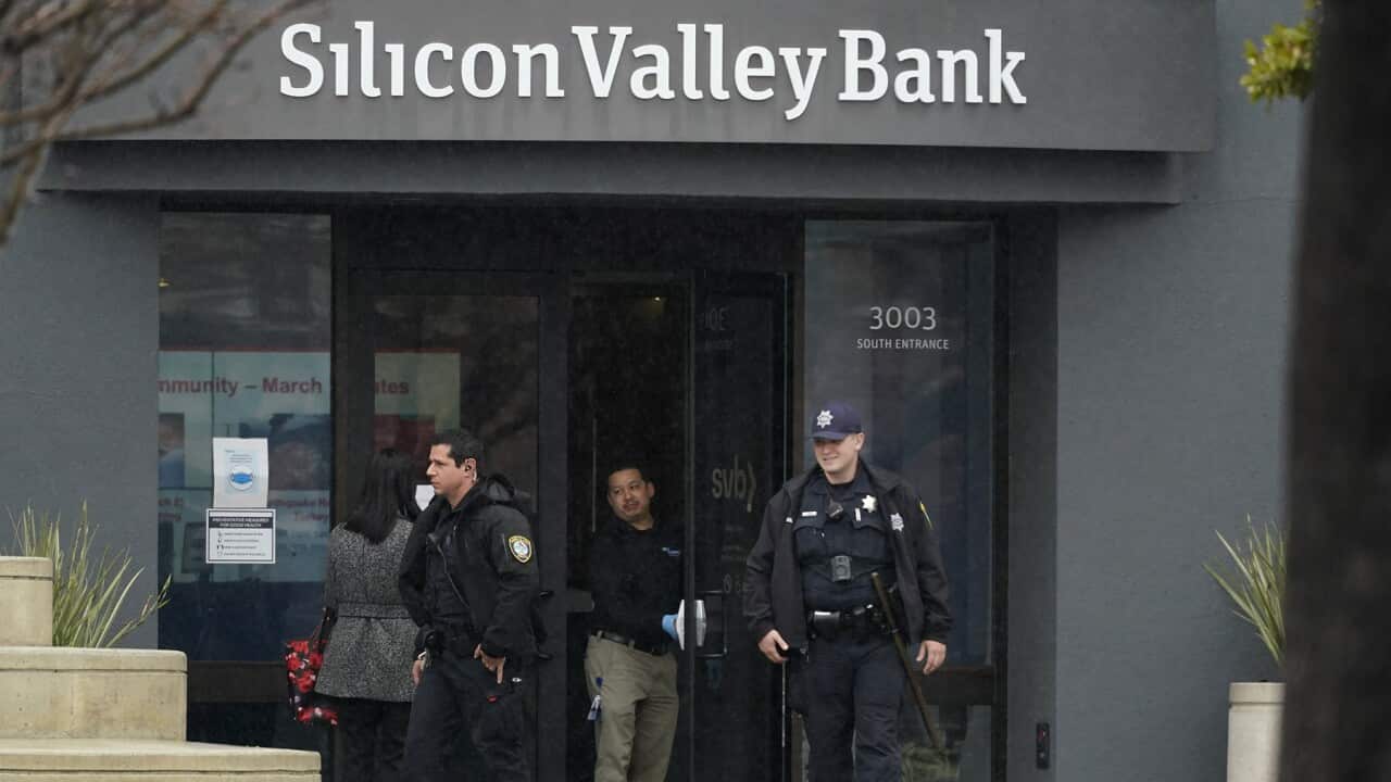 Police officers leave a bank.