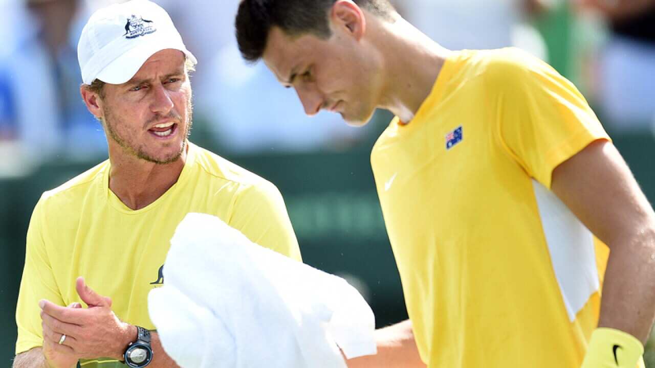 Australian captain Lleyton Hewitt (L) coaches Bernard Tomic