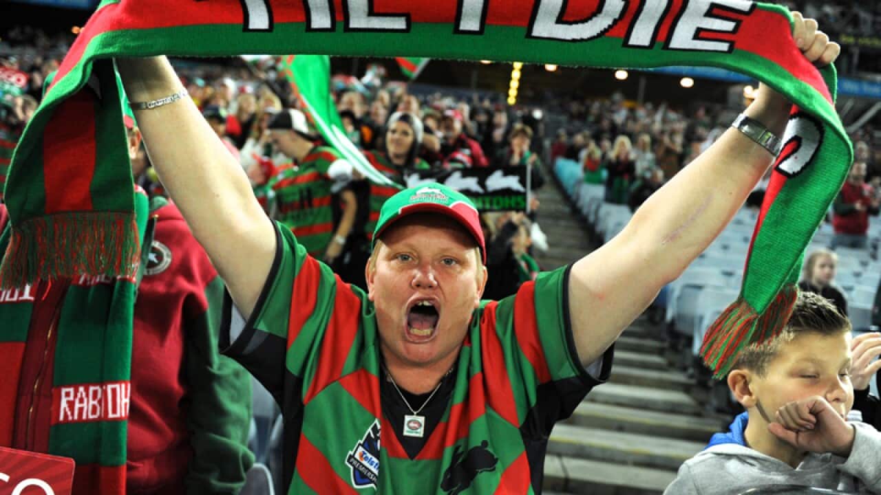 A Rabbitohs fan celebrates at ANZ Stadium