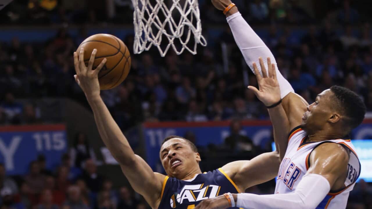 Utah Jazz guard Dante Exum (11) shoots in front of Russell Westbrook