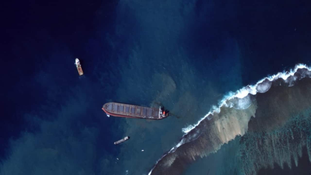 A handout satellite image made available by MAXAR Technologies shows the MV Wakashio leaking oil
