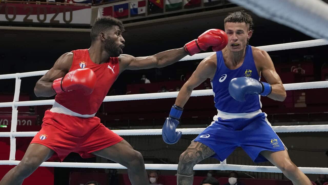 Two men competing in a boxing match.