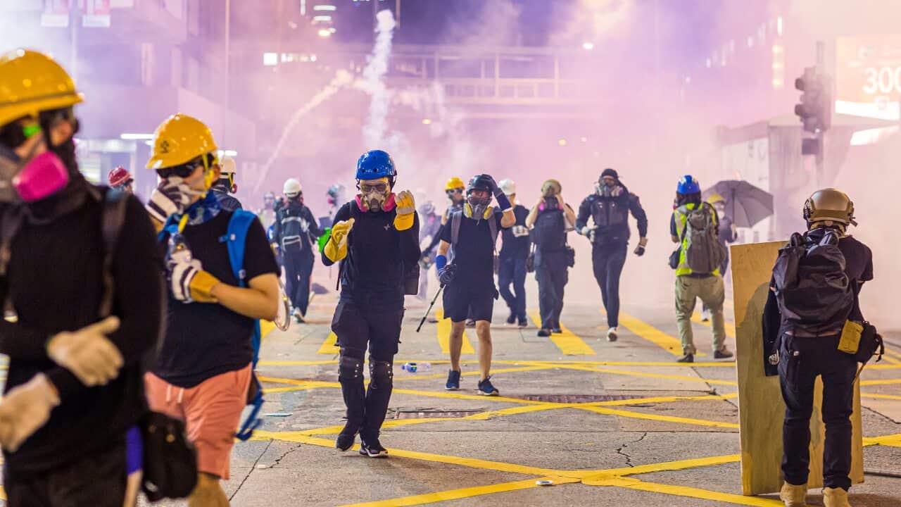 Demonstrators flee from tear gas during the protests against the extradition bill in Hong Kong.