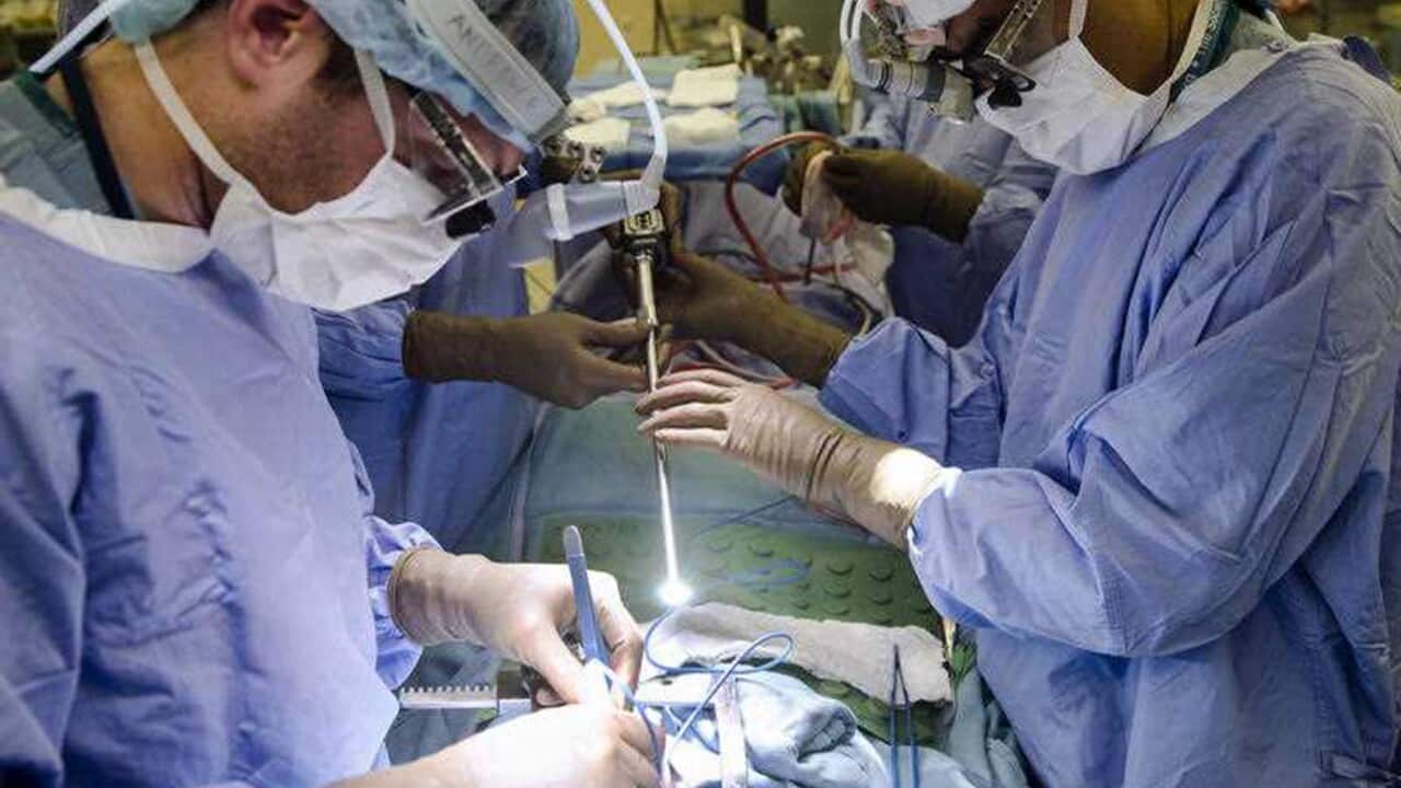 A surgeon operates on a patient in hospital (AAP).jpg