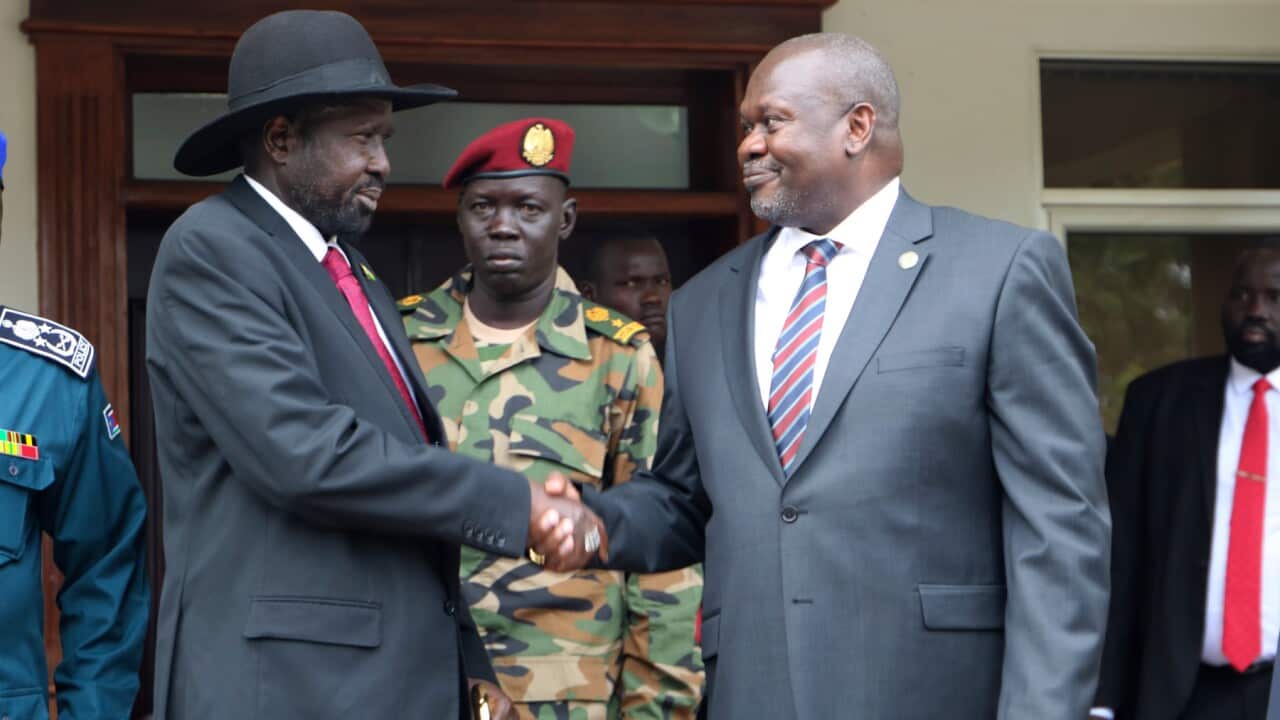 South Sudan's President Salva Kiir left, and opposition leader Riek Machar, right, shake hands after meetings in October (AAP)