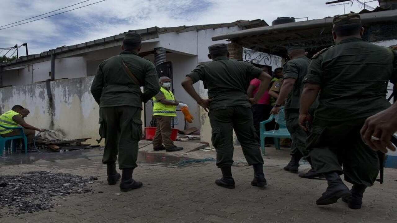 Army officers collect evidence after a gunbattle with militants