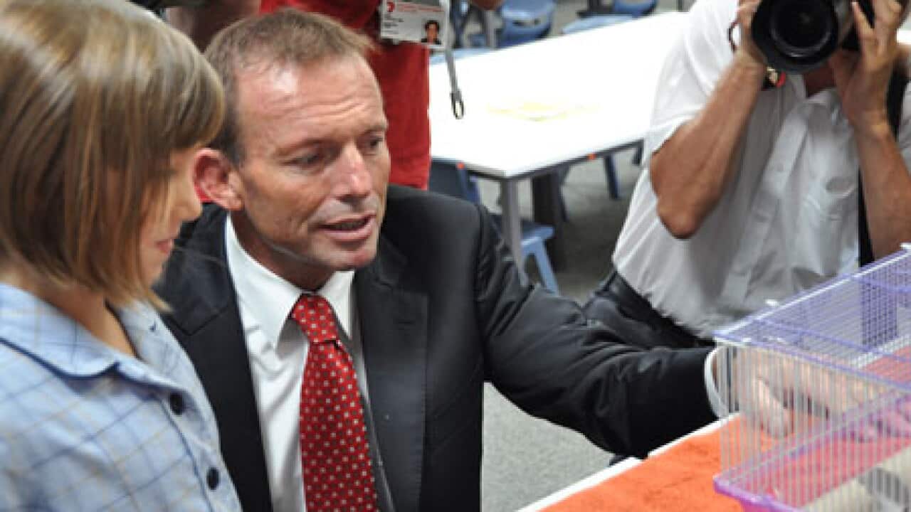 Tony_abbott_100721_aap_with_child_school_L_2031754507