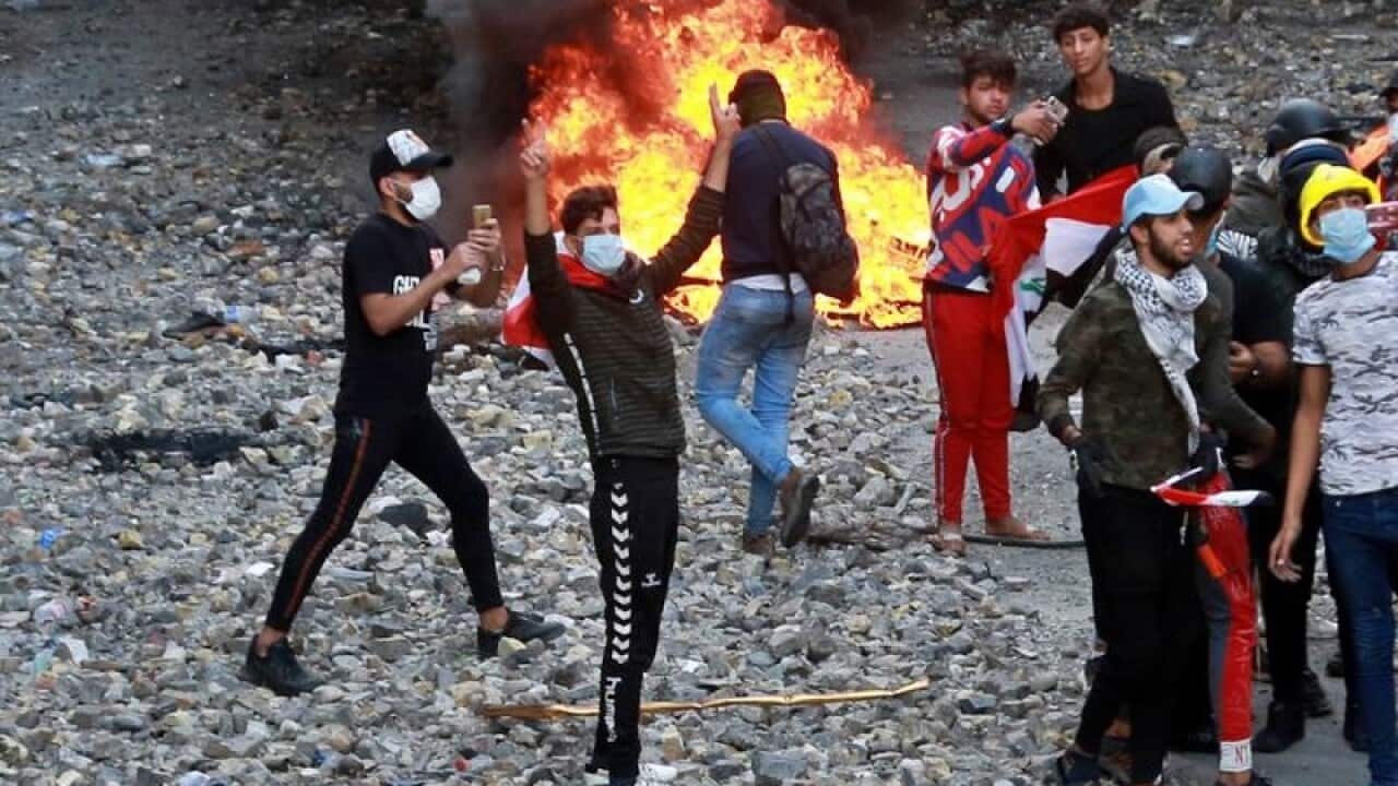 Protesters start fires during clashes in Baghdad