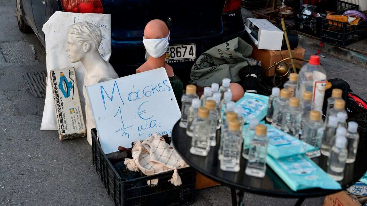 Masks marked "1 Euro each" and antiseptics are displayed for sale at a flea market in Athens on March 15 amid the outbreak of COVID-19