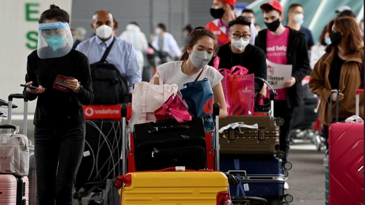 International students wear face masks as they arrive at Sydney Airport in Sydney.