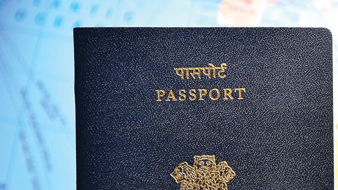 Close-up of Indian passport lying on world map