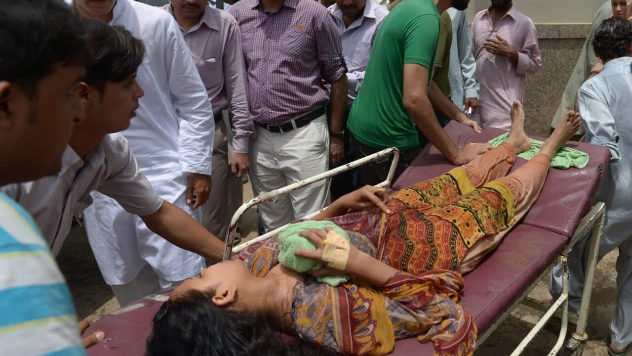 Pakistani relatives shift a heatstroke victim to a hospital in Karachi on June 24, 2015. (RIZWAN TABASSUM/AFP/Getty Images)