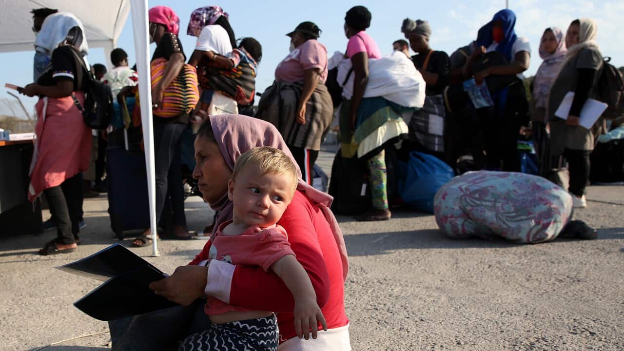 Asylum seekers wait in line to enter a refugee camp on Lesbos island, Greece.