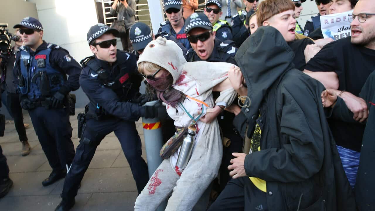 Protesters and police outside the The International Mining and Resources Conference in Melbourne on Wednesday.