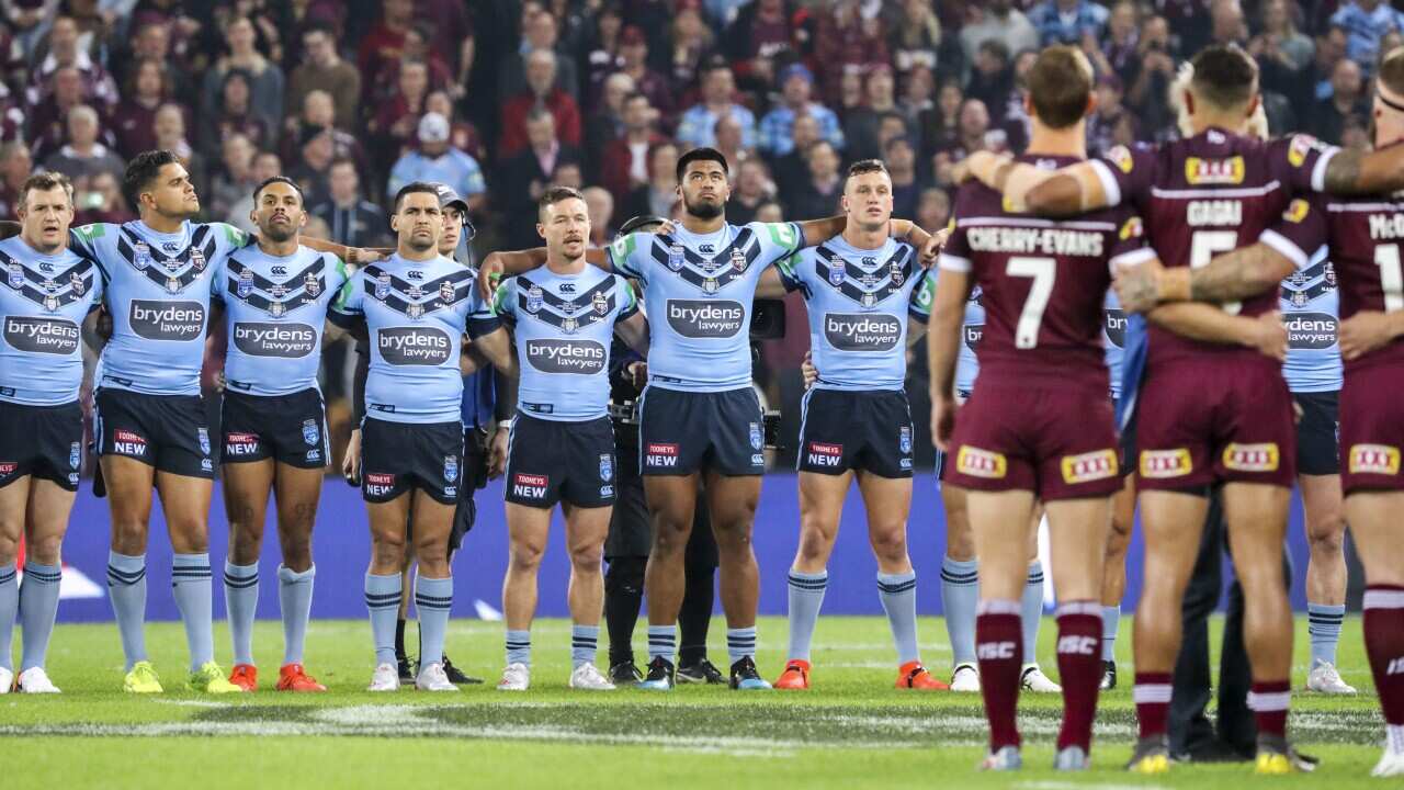 QLD Maroons and NSW Blues players line up for the National Anthem before Game 1 of the 2019 State of Origin series.