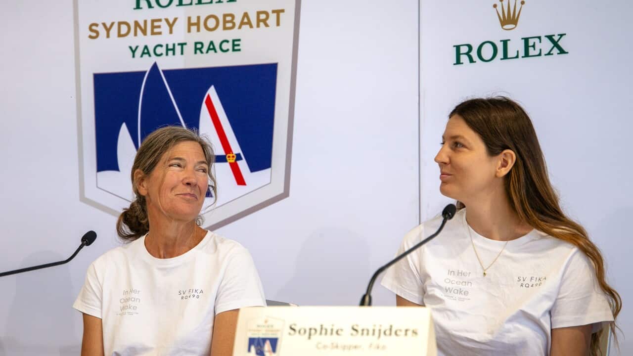 Annette Hesselmans and Sophie Snijders smile at each other.
