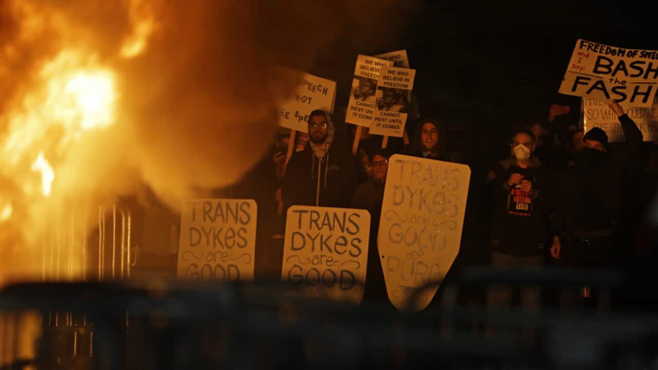 Protesters watch a fire at the University of California at Berkeley