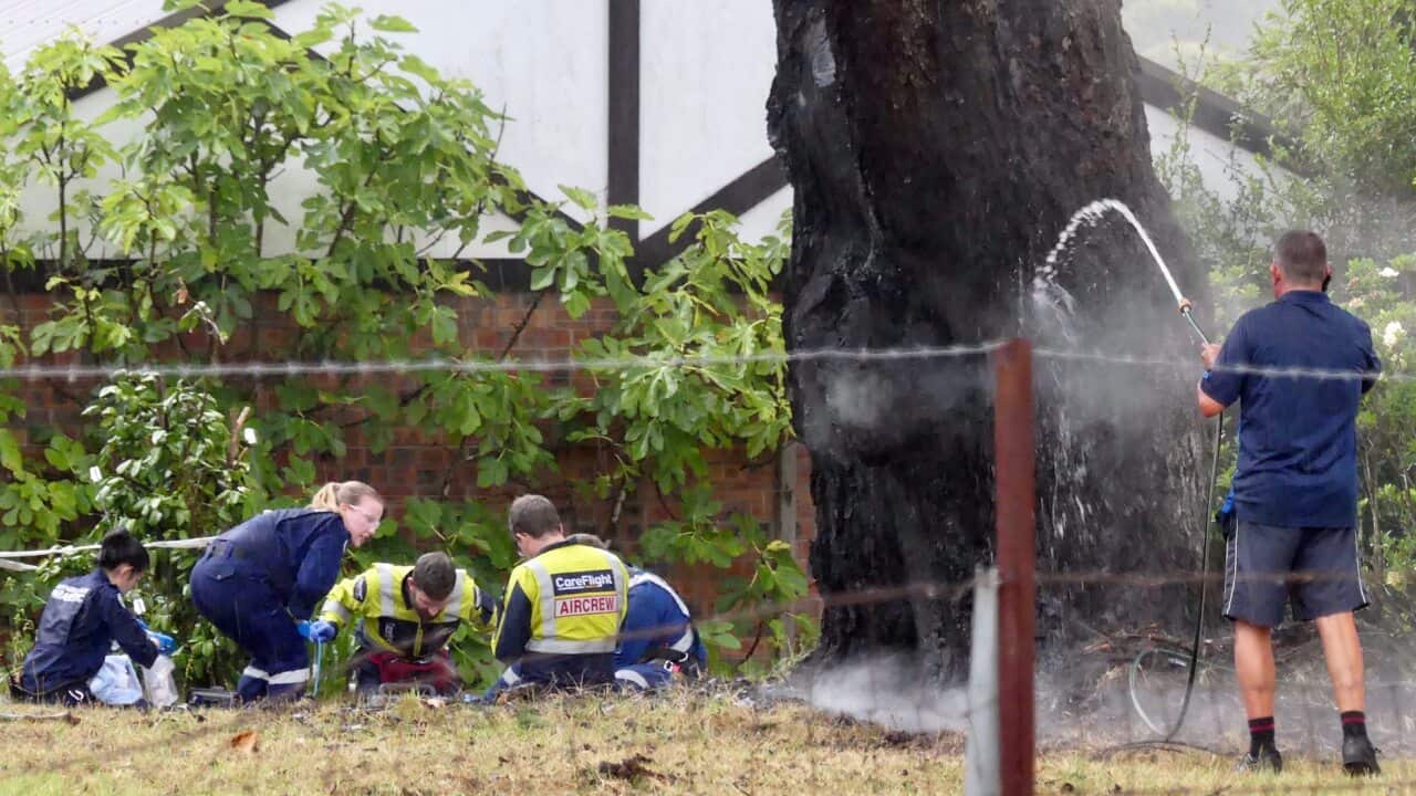 Paramedics administer CPR to a woman who was struck by lightning standing underneath a tree in her Arcadia residence.