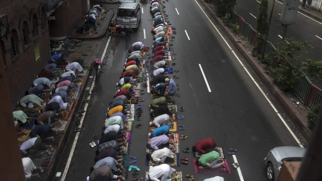 Muslims offer prayers in the middle of the road during the covid-19 lockdown