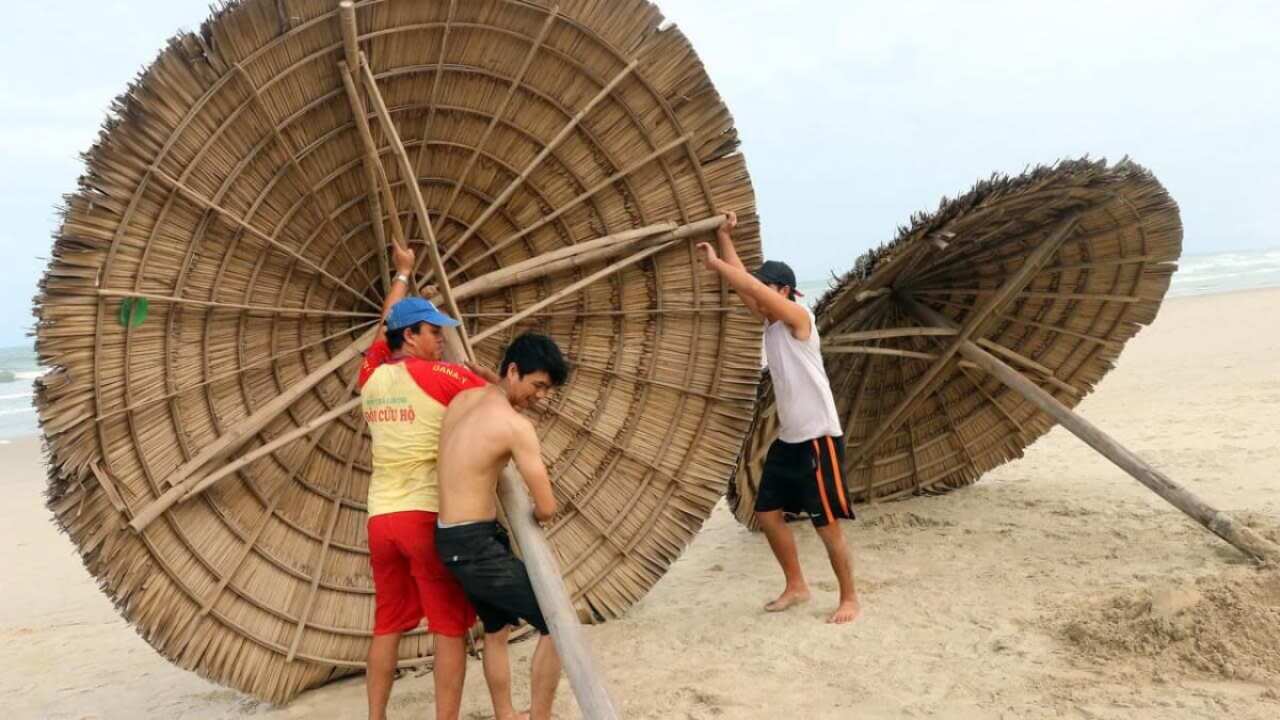 People remove beach cabanas ahead of the arrival of Typhoon Molave, in Danang, Vietnam.