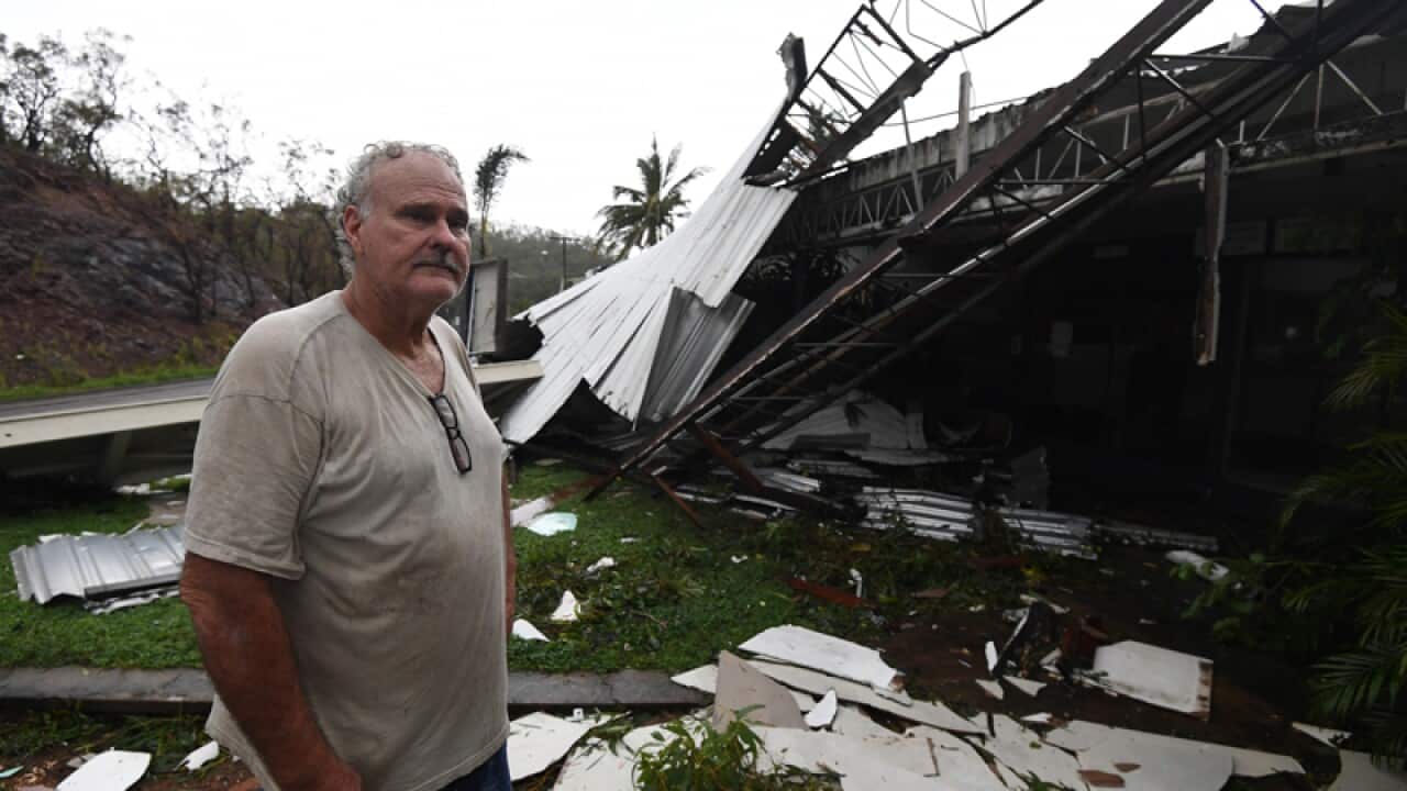 Dave Mcinnerney inspects the damage to his motel at Shute Harbour