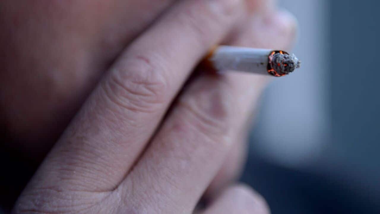 A smoker puffs on a cigarette