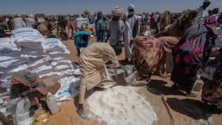 South Sudanese refugees line up for flour