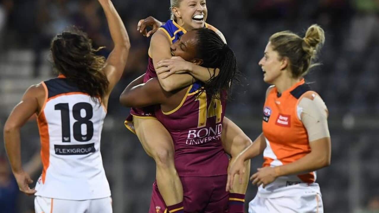 Kate McCarthy of the Lions jumps on Sabrina Frederick-Traub.