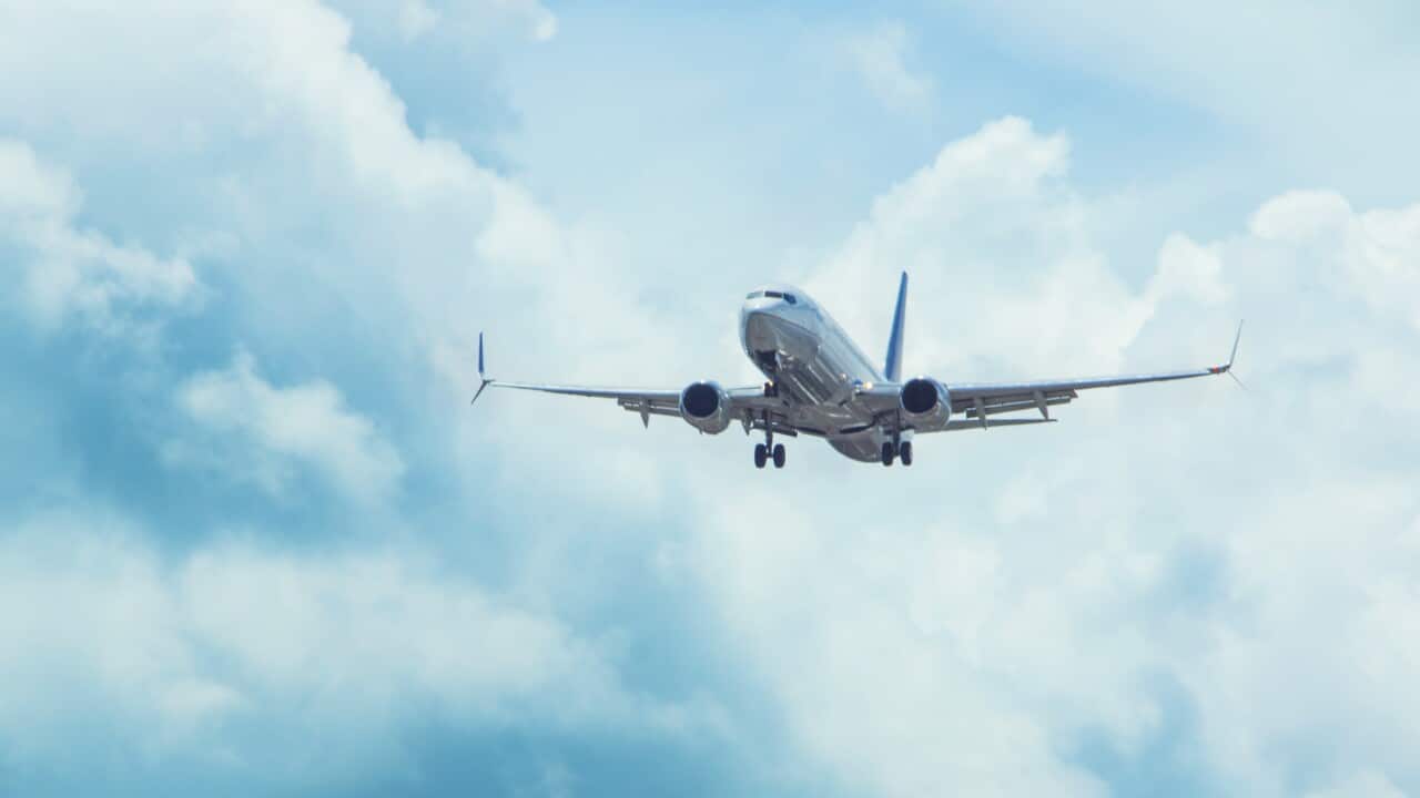 Low Angle View Of Airplane Flying In Sky